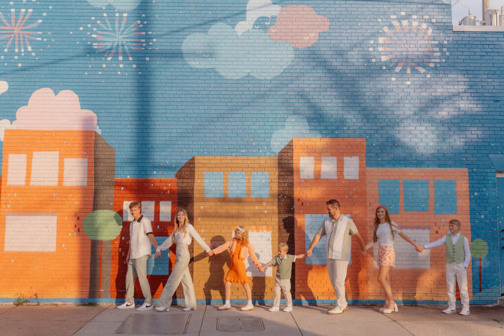 family in front of a mural