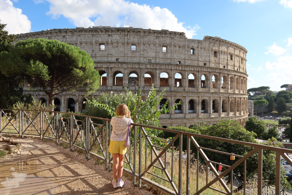 picture of he colliseum with a kid in front